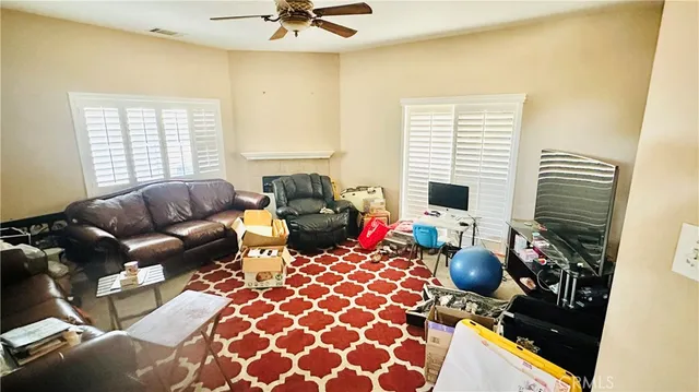 a living room with furniture fireplace and a window