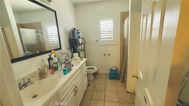 a spacious bathroom with a bathtub a sink and a mirror