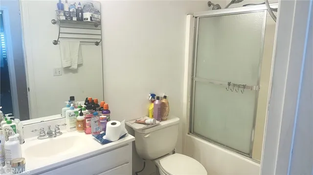 a bathroom with a sink vanity mirror and toilet