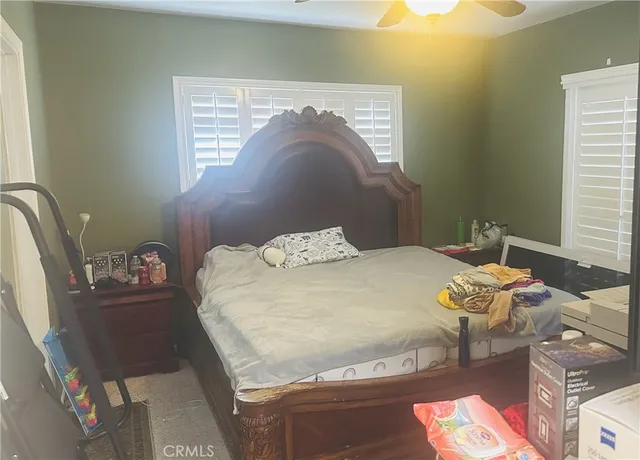 a bed sitting in a bedroom next to a window