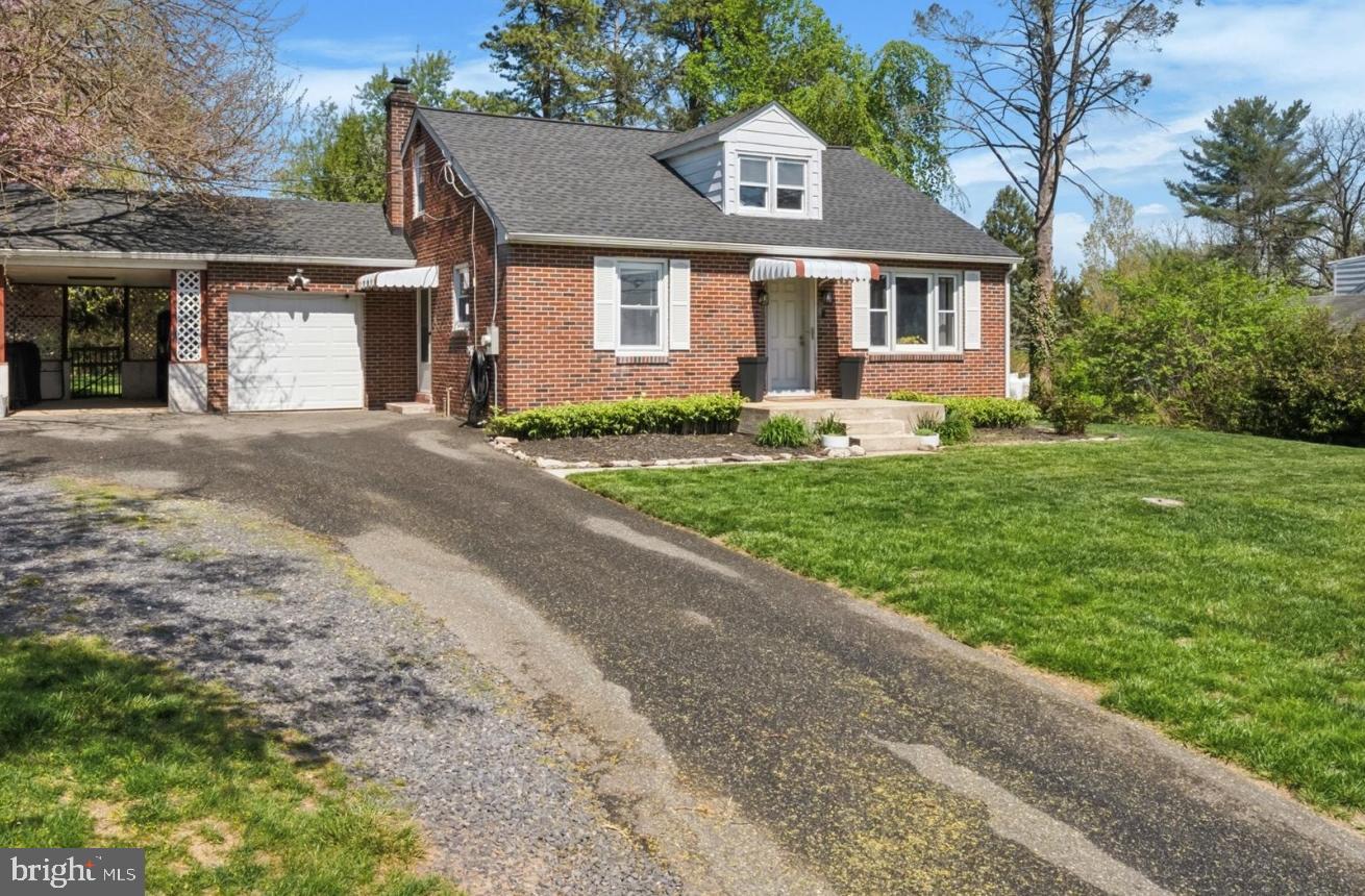134-7 East 7 Stars Road Phoenixville, PA 19460 - Photo 2 of 25 a front view of a house with a yard and garage
