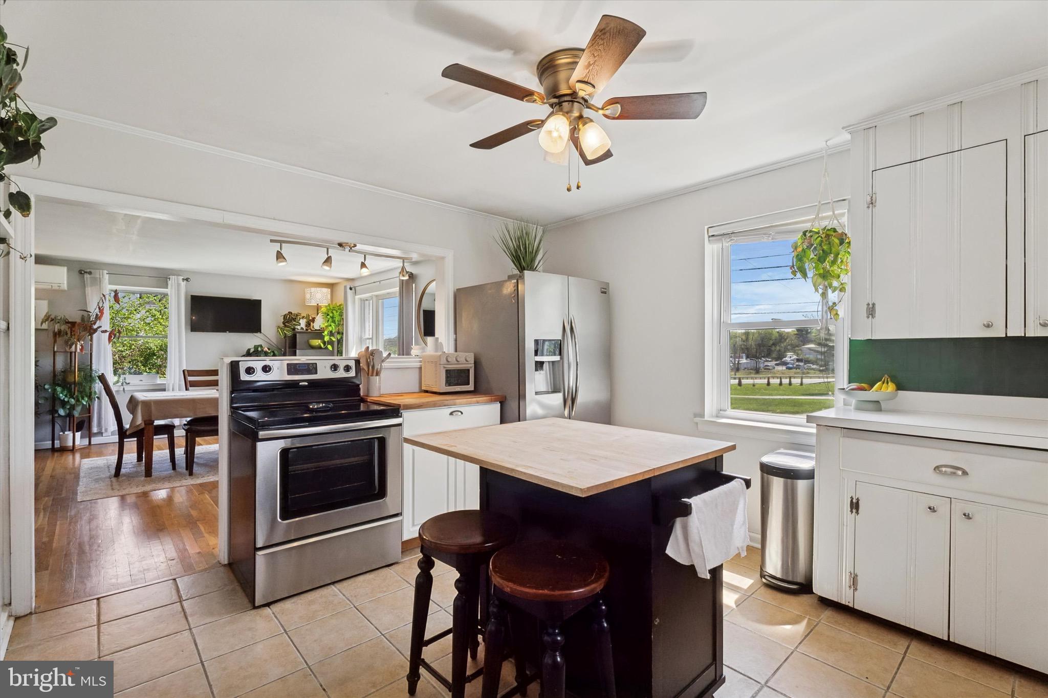 134-7 East 7 Stars Road Phoenixville, PA 19460 - Photo 4 of 25 a kitchen with a stove a sink a dining table and chairs