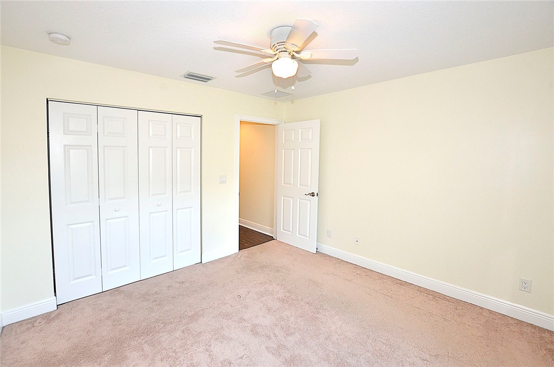 4899 Kirby Loop Road Fort Pierce, FL 34981 - Photo 20 of 32 an empty room with fan and a ceiling fan