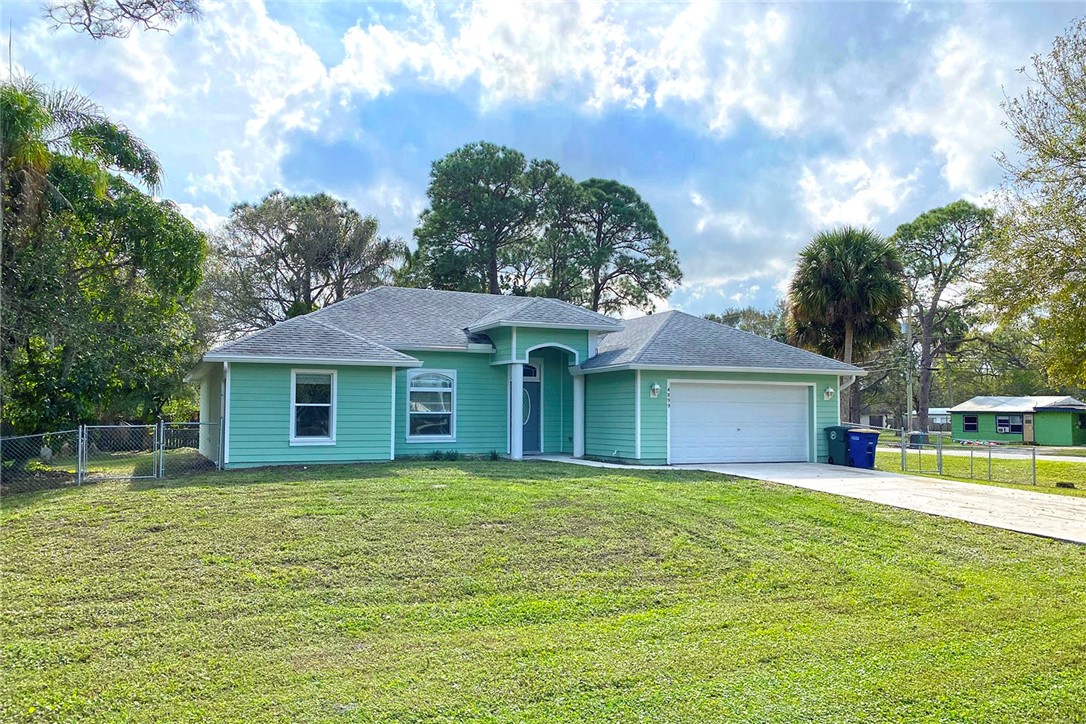 4899 Kirby Loop Road Fort Pierce, FL 34981 - Photo 25 of 32 a house view with a sitting space and garden