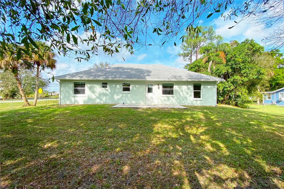 4899 Kirby Loop Road Fort Pierce, FL 34981 - Photo 28 of 32 a front view of a house with a garden