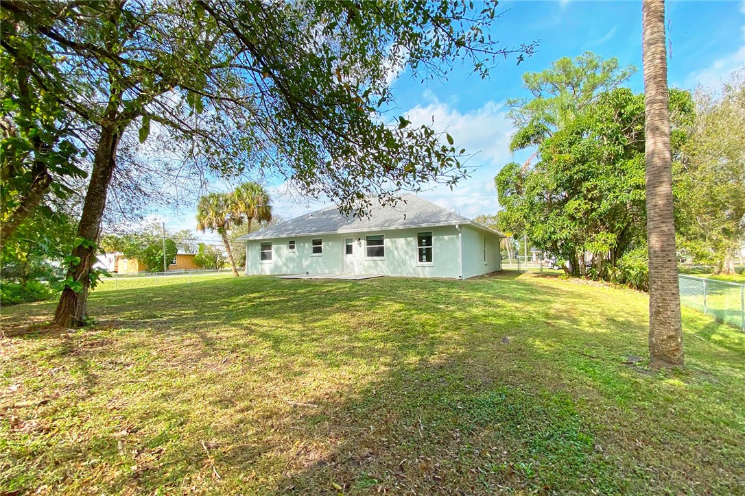 4899 Kirby Loop Road Fort Pierce, FL 34981 - Photo 29 of 32 a front view of a house with garden