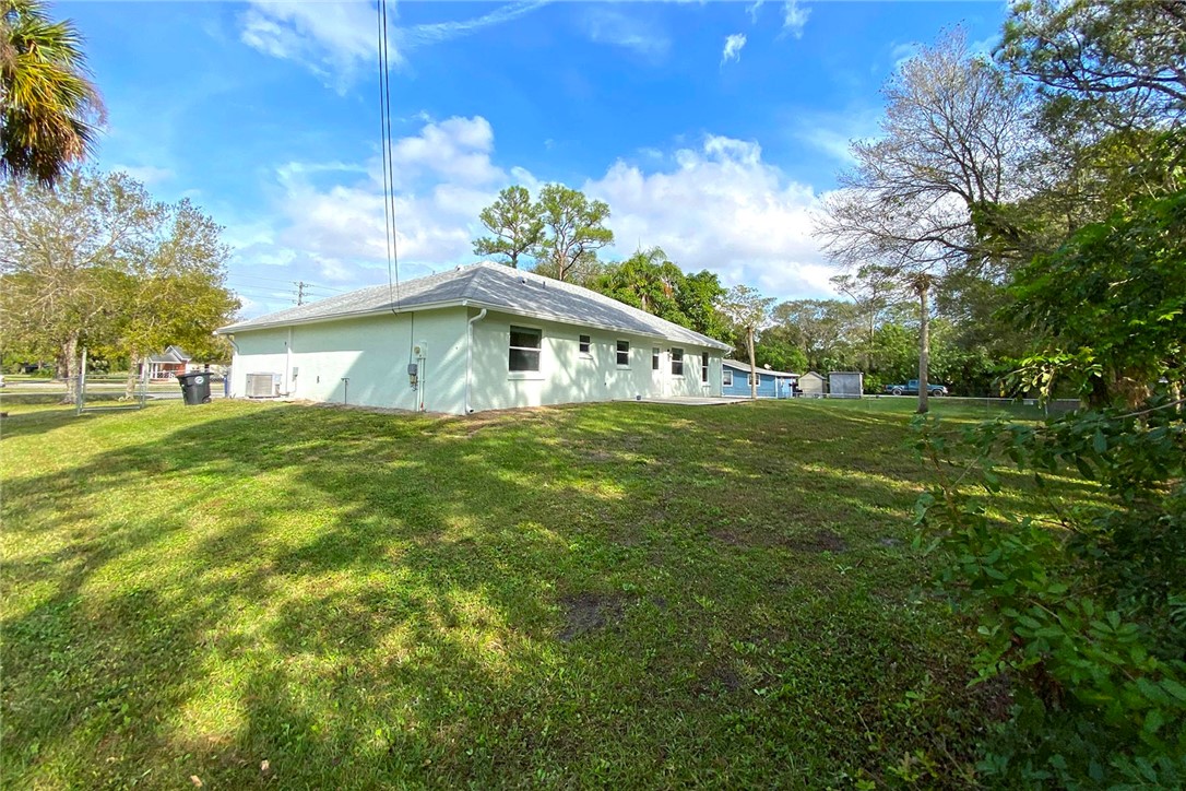 4899 Kirby Loop Road Fort Pierce, FL 34981 - Photo 30 of 32 a view of a house with a yard