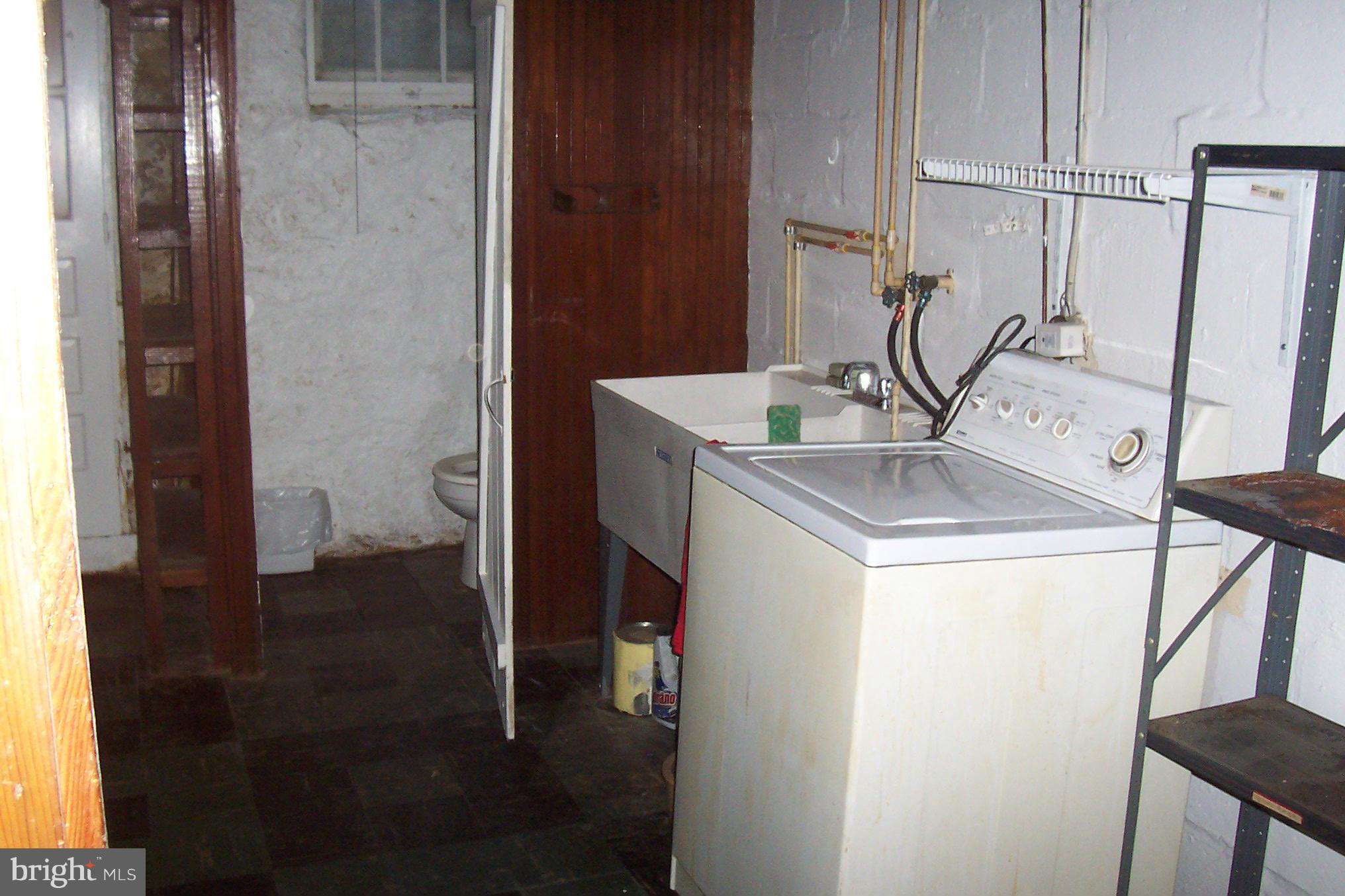 3704 Delverne Road Baltimore, MD 21218 - Photo 15 of 17 a bathroom with a sink and a mirror