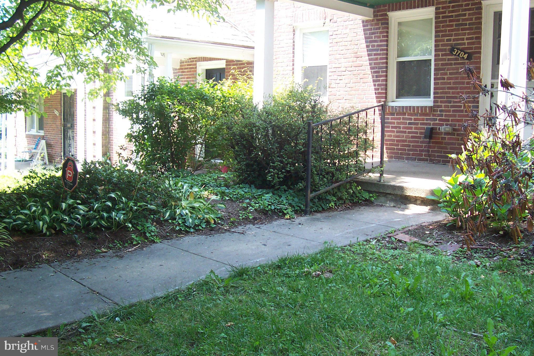 3704 Delverne Road Baltimore, MD 21218 - Photo 16 of 17 a view of a backyard with plants and large trees
