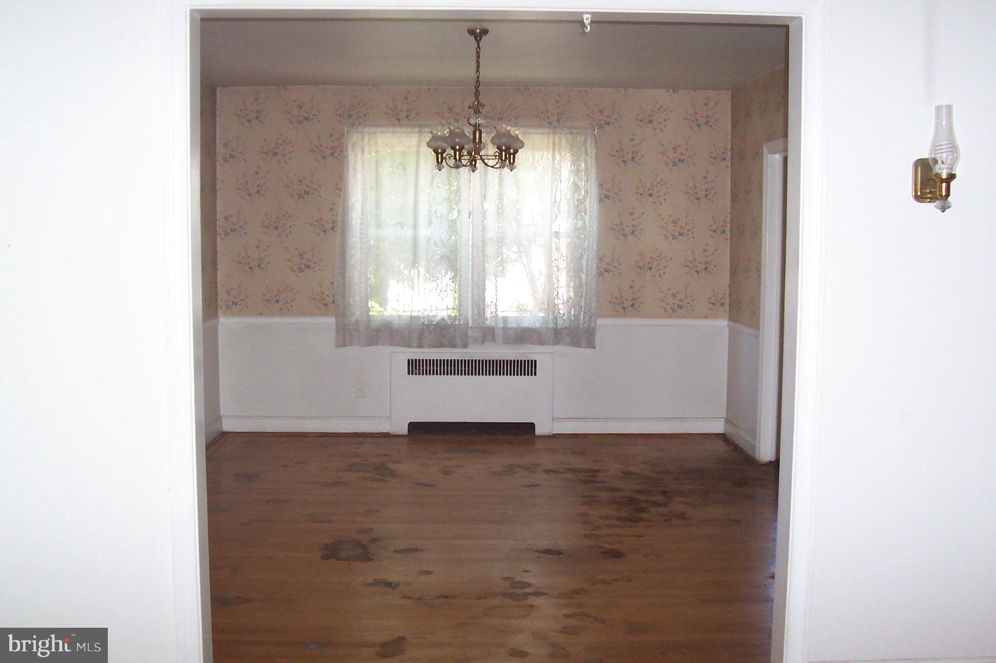 3704 Delverne Road Baltimore, MD 21218 - Photo 6 of 17 a view of an empty room with a window