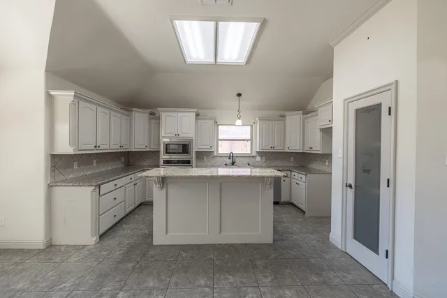 a kitchen with cabinets and window
