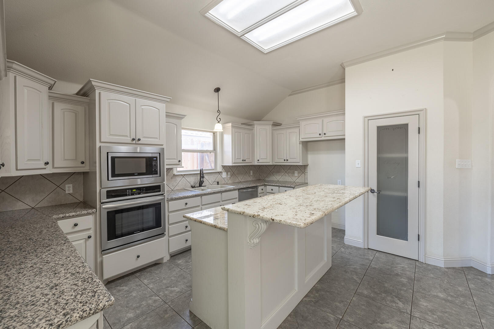 6406 93rd Street Lubbock, TX 79424 - Photo 14 of 40 a kitchen with stainless steel appliances granite countertop a stove top oven a sink and a refrigerator
