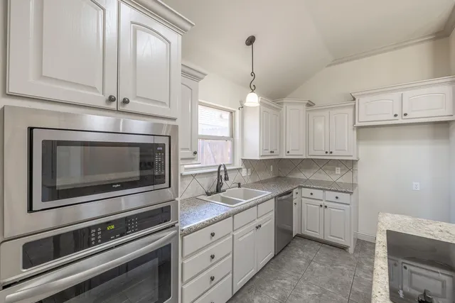 a kitchen with appliances cabinets and a sink
