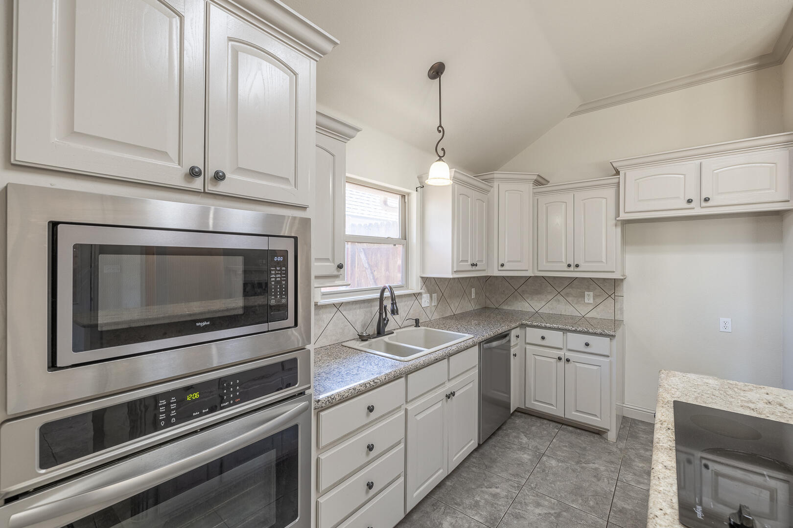 6406 93rd Street Lubbock, TX 79424 - Photo 15 of 40 a kitchen with appliances cabinets and a sink