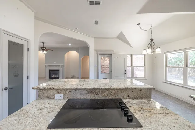 a large bathroom with a granite countertop sink and a mirror