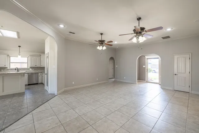 a view of a kitchen with a sink and a chandelier fan