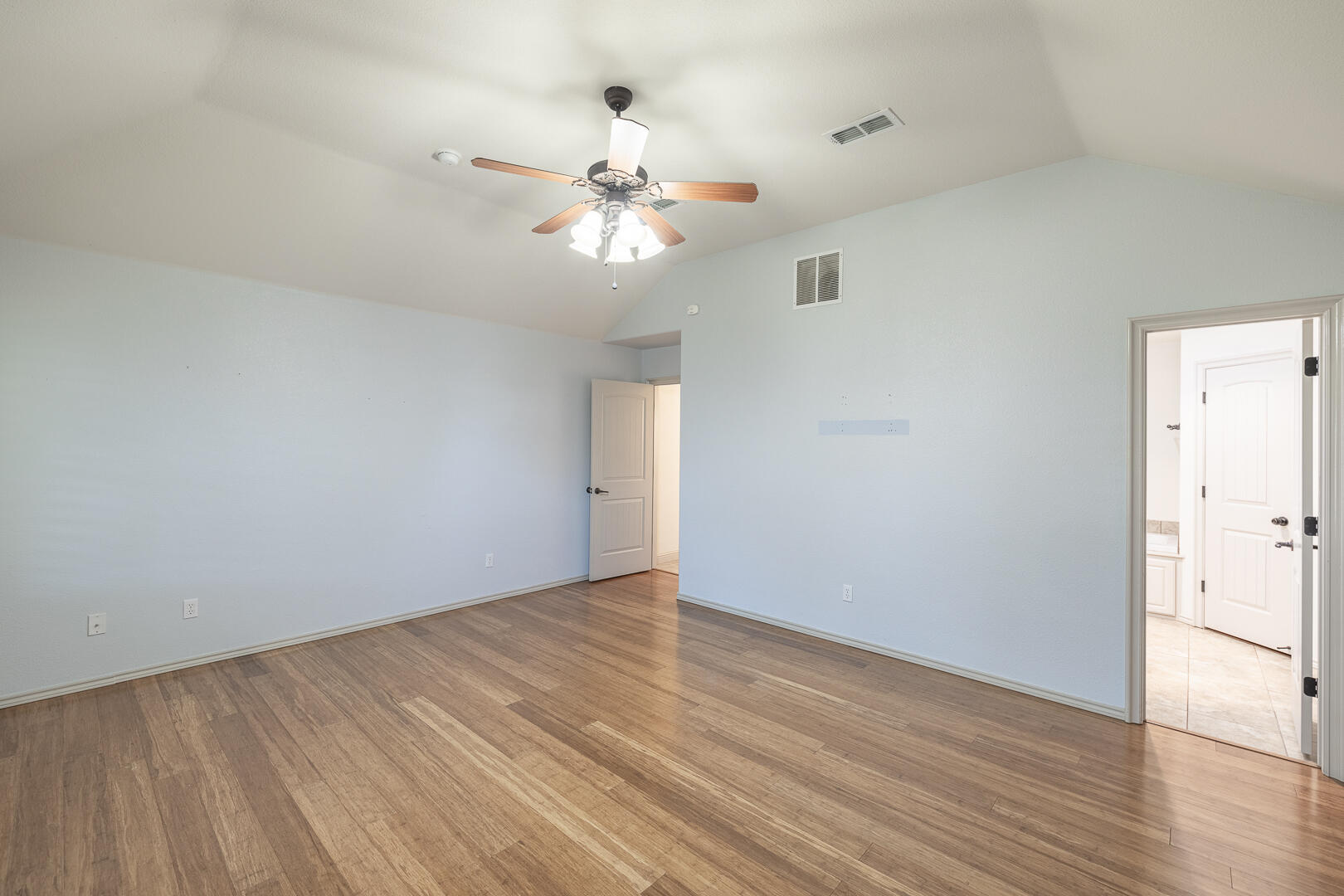 6406 93rd Street Lubbock, TX 79424 - Photo 21 of 40 a view of an empty room with wooden floor