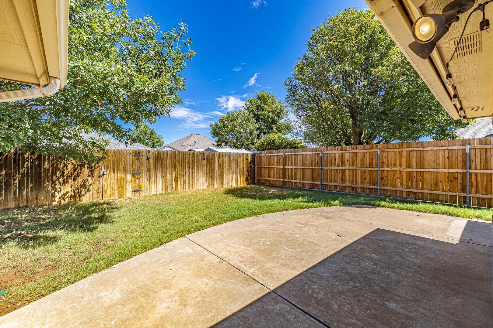 6406 93rd Street Lubbock, TX 79424 - Photo 35 of 40 a view of a backyard with wooden fence