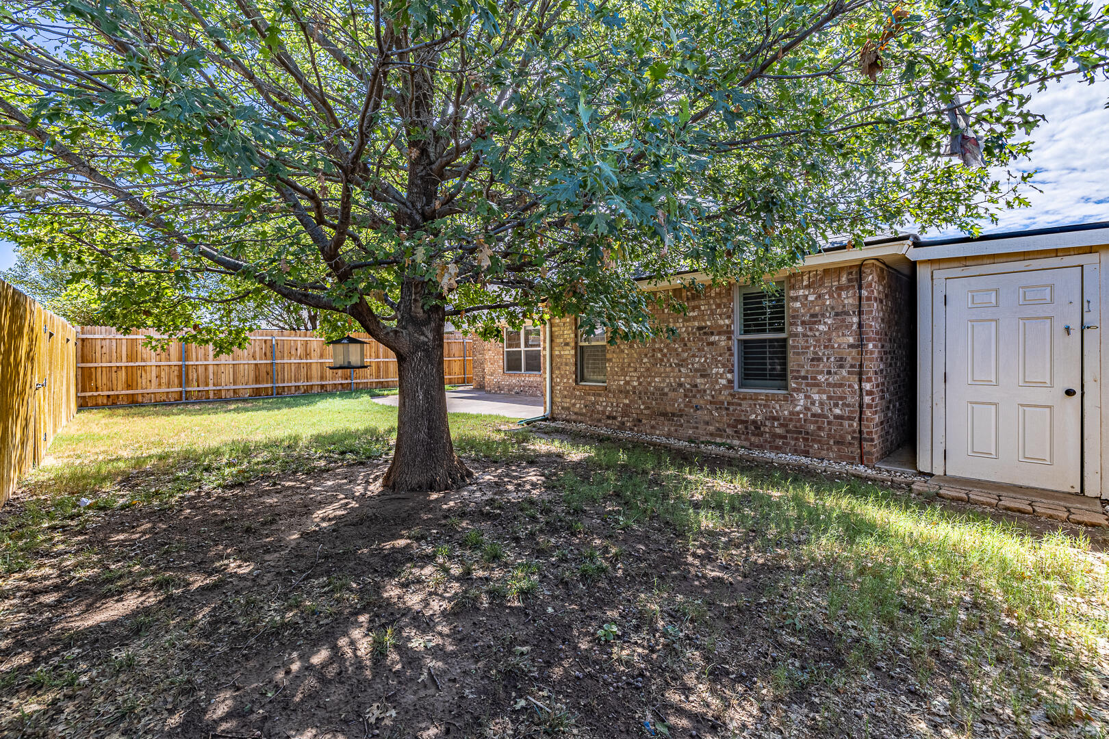6406 93rd Street Lubbock, TX 79424 - Photo 39 of 40 a backyard of a house with lots of green space