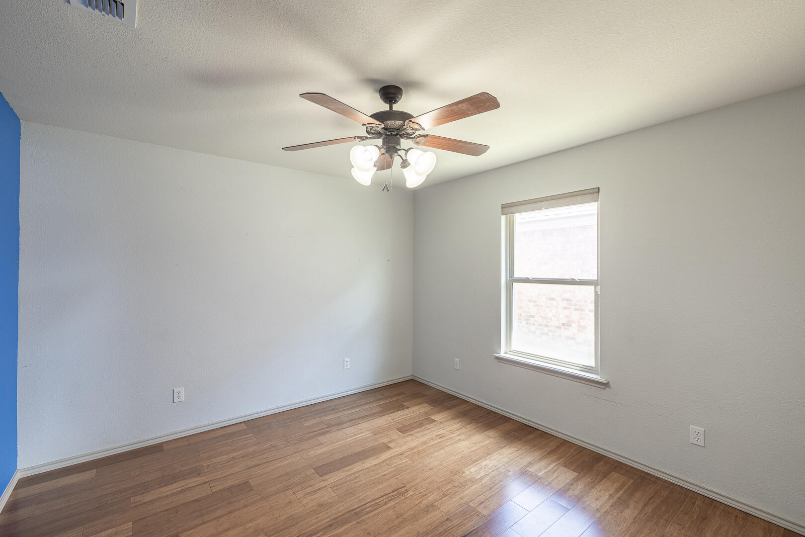 6406 93rd Street Lubbock, TX 79424 - Photo 7 of 40 an empty room with wooden floor and windows