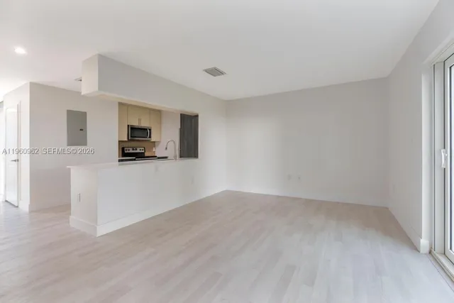 a view of a kitchen with electric appliances