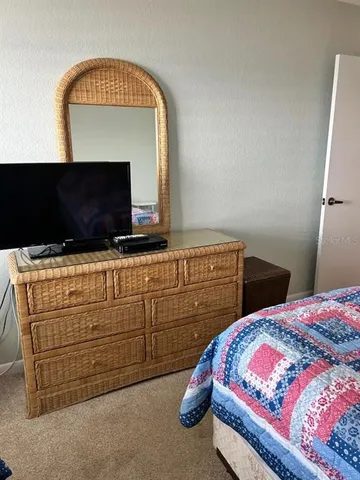 a bedroom with a bed and a television