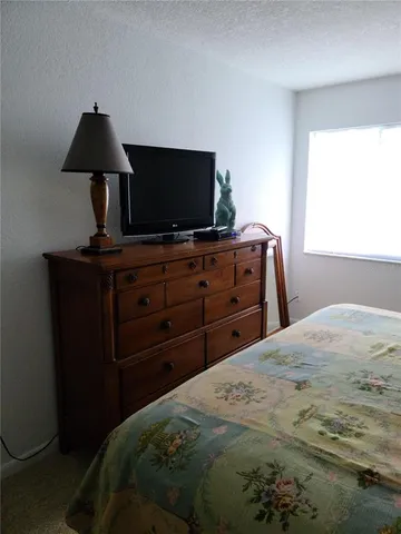 a bedroom with bed and window