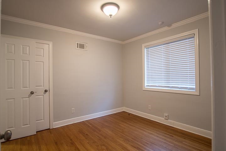 3780 Cardinal Avenue Memphis, TN 38111 - Photo 12 of 19 a view of an empty room with wooden floor and a window