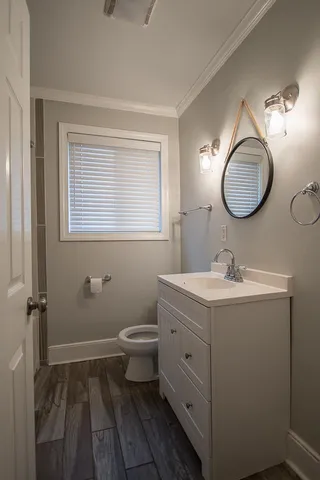 a bathroom with a toilet sink and mirror