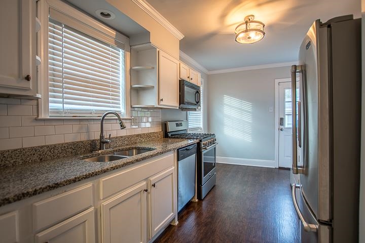 3780 Cardinal Avenue Memphis, TN 38111 - Photo 3 of 19 a kitchen with granite countertop a refrigerator a sink and wooden floor