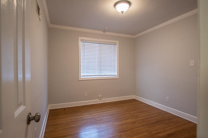3780 Cardinal Avenue Memphis, TN 38111 - Photo 5 of 19 wooden floor in an empty room with a window
