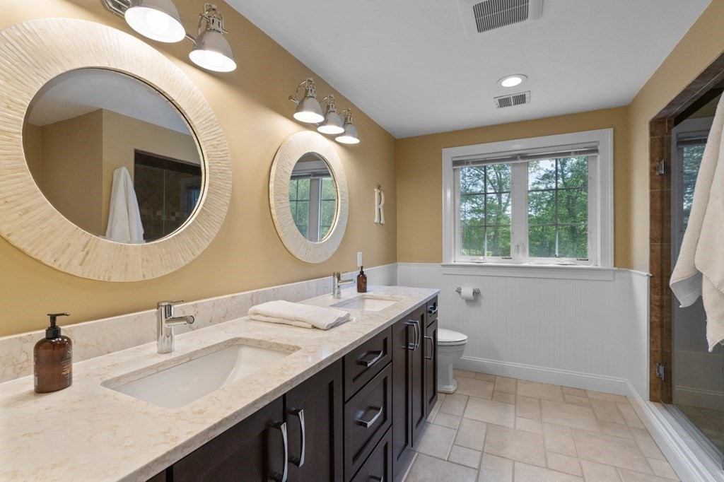20 Walden Drive Walpole, MA 02081 - Photo 15 of 38 a bathroom with a double vanity sink and a mirror