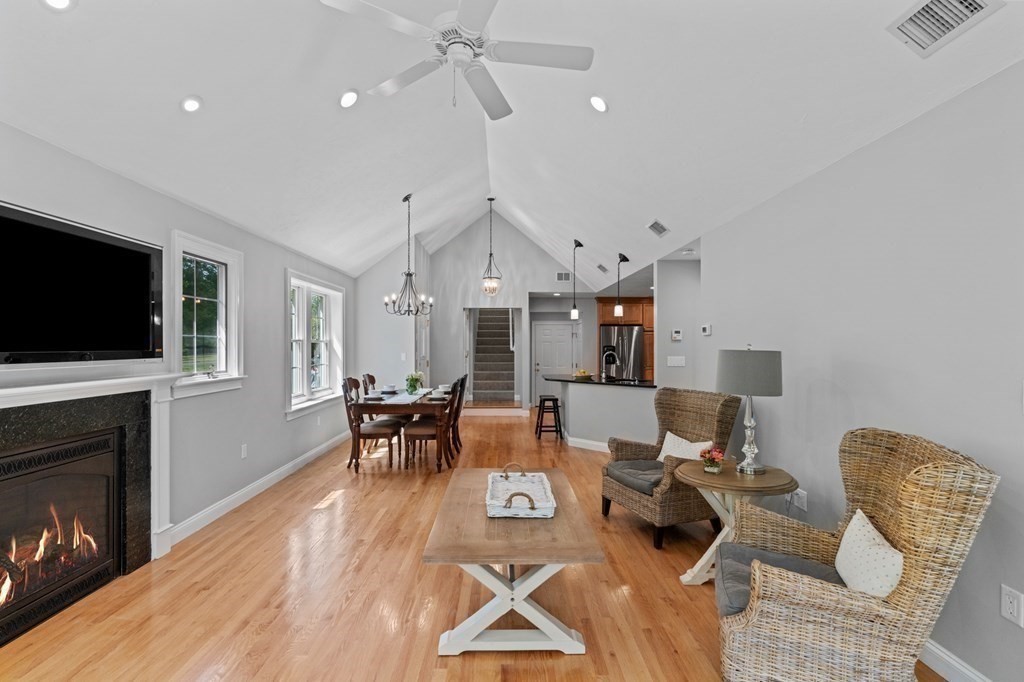 20 Walden Drive Walpole, MA 02081 - Photo 29 of 38 a living room with furniture a flat screen tv and a fireplace