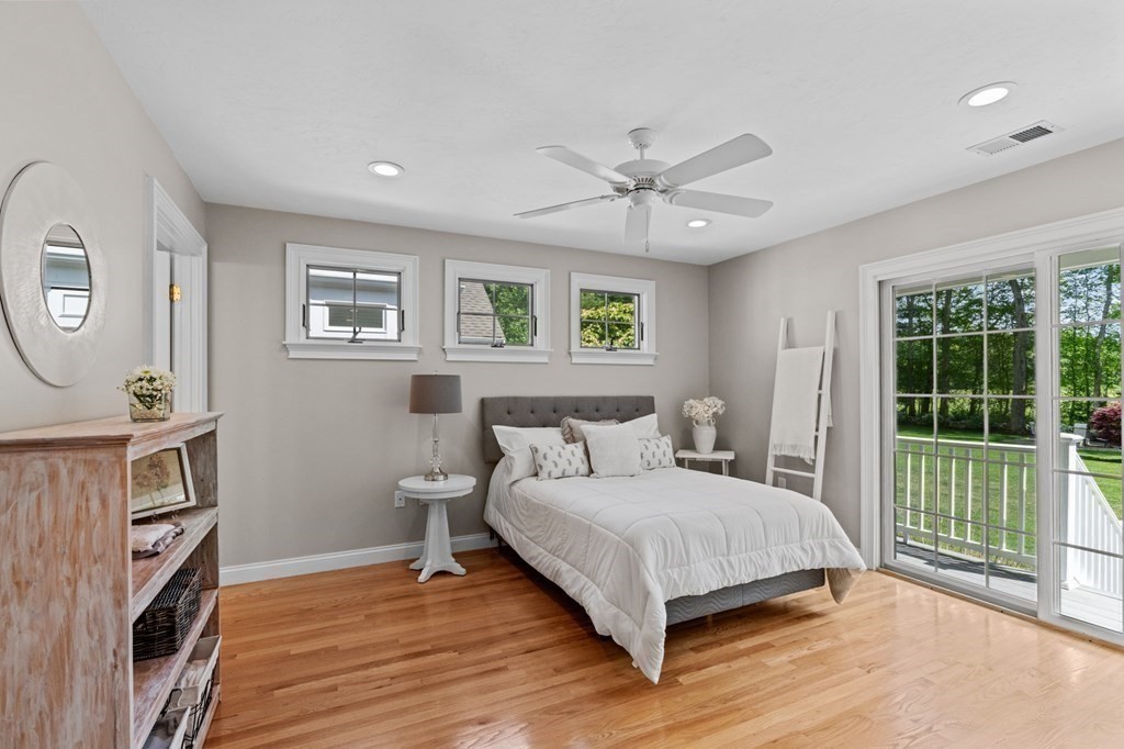 20 Walden Drive Walpole, MA 02081 - Photo 30 of 38 a bedroom with a large bed a flat tv screen and a large window