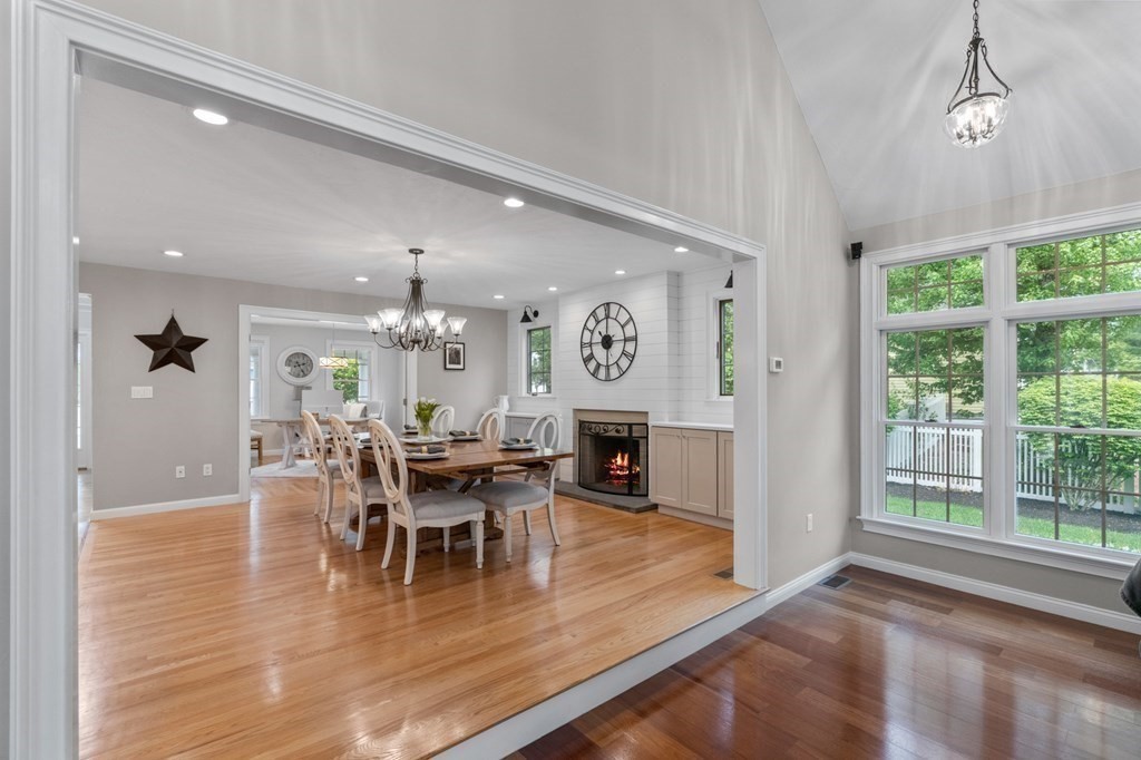 20 Walden Drive Walpole, MA 02081 - Photo 5 of 38 a dining room with wooden floor a chandelier a glass table and chairs