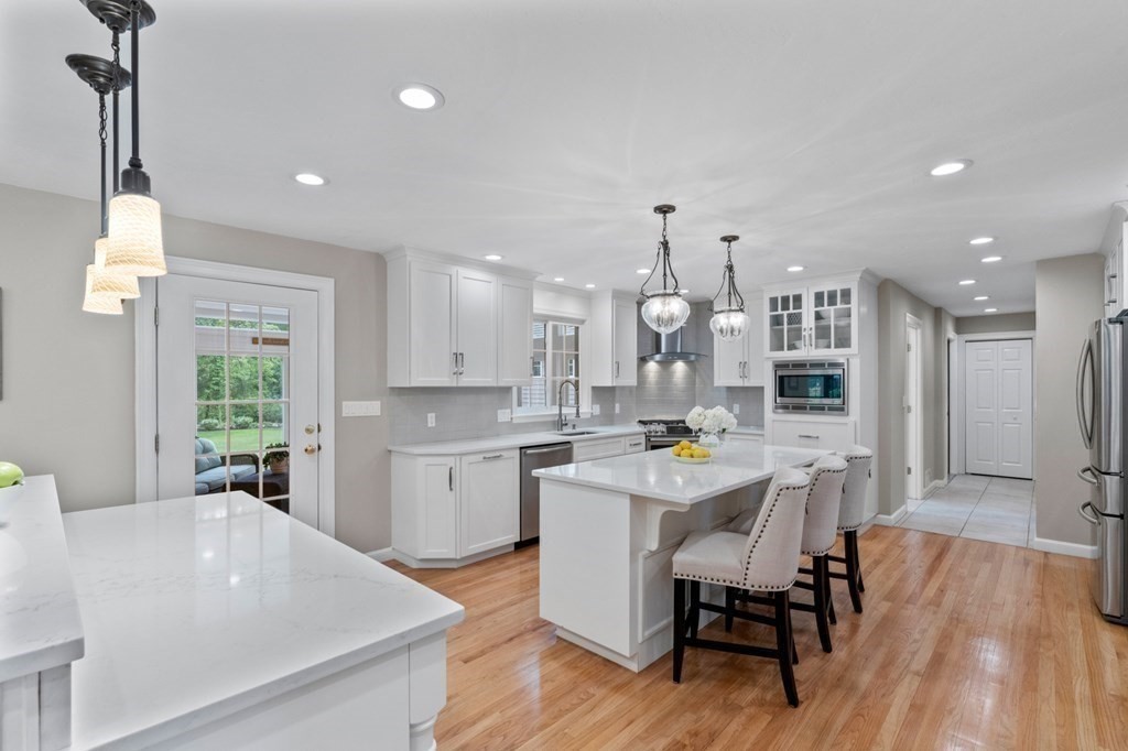 20 Walden Drive Walpole, MA 02081 - Photo 7 of 38 a kitchen with sink cabinets and wooden floor