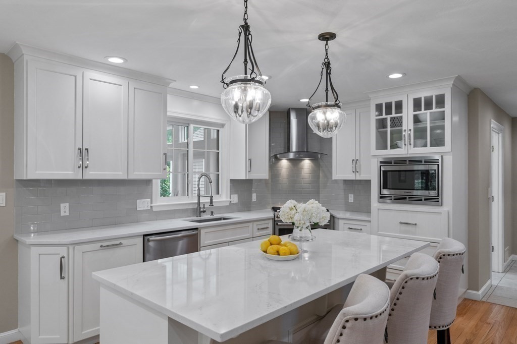 20 Walden Drive Walpole, MA 02081 - Photo 9 of 38 a kitchen with sink cabinets and chandelier