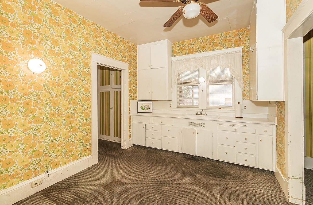 1005 L Street Reedley, CA 93654 - Photo 26 of 37 a bathroom with a sink a mirror and a shower
