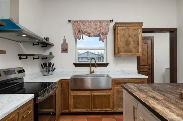 a kitchen with a sink and a refrigerator