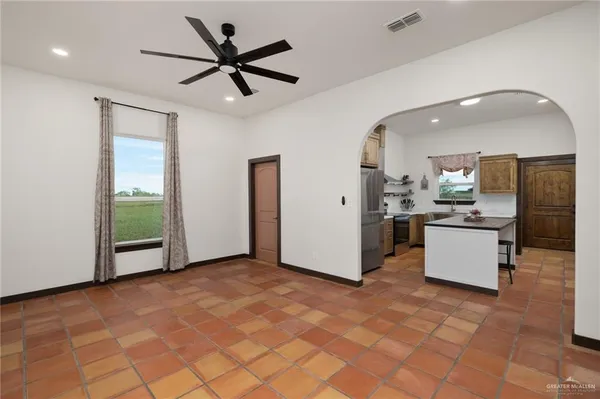 a view of kitchen with stainless steel appliances granite countertop a refrigerator and a sink