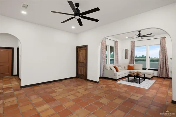 a living room with furniture and large windows