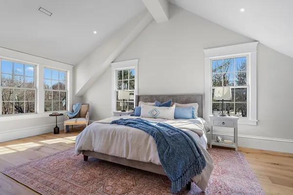 a bedroom with a bed and large window