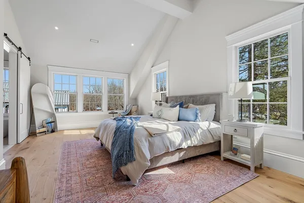 a spacious bedroom with a large bed and a large window