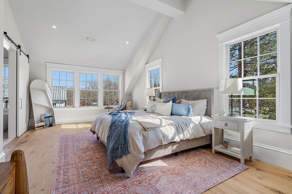 16 Hatch Farm Lane, Unit 16 Concord, MA 01742 - Photo 15 of 39 a spacious bedroom with a large bed and a large window