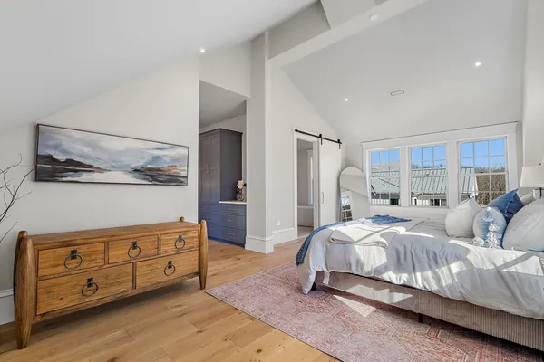 a bedroom with a bed and with furniture