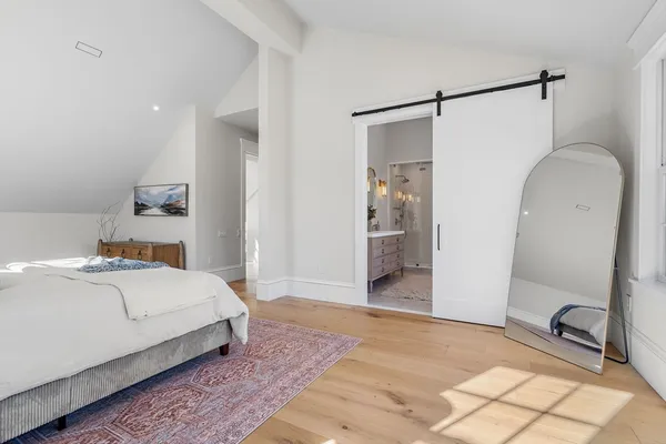 a room with a bed and a mirror