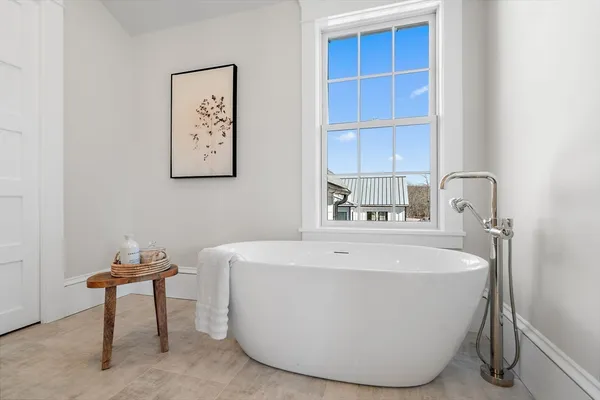 a white bath tub sitting in a bathroom