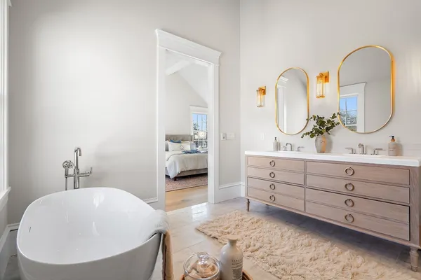a spacious bathroom with a double vanity sink and a mirror