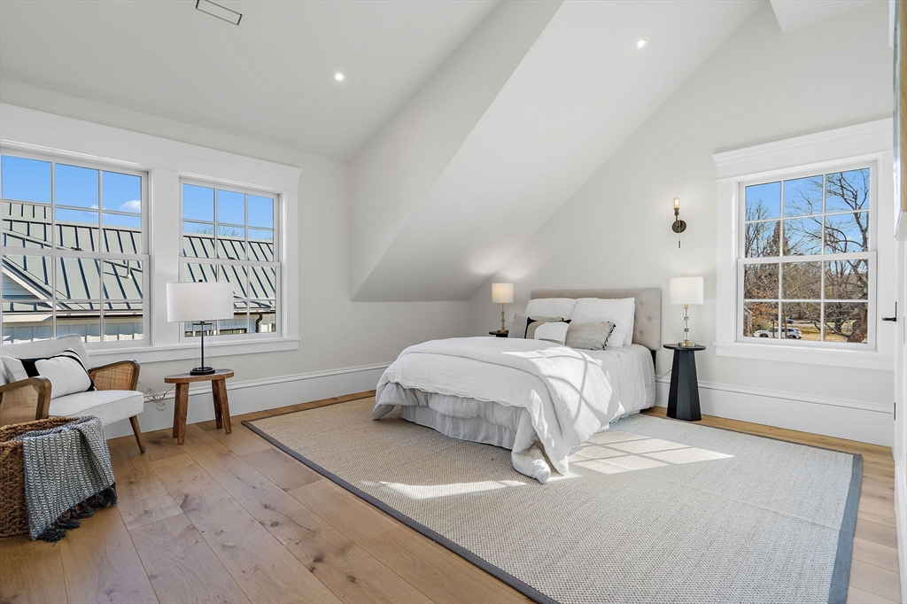 16 Hatch Farm Lane, Unit 16 Concord, MA 01742 - Photo 26 of 39 a bedroom with a bed and wooden floor
