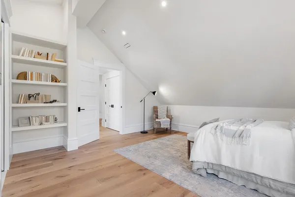 a bedroom with a bed and a book shelf